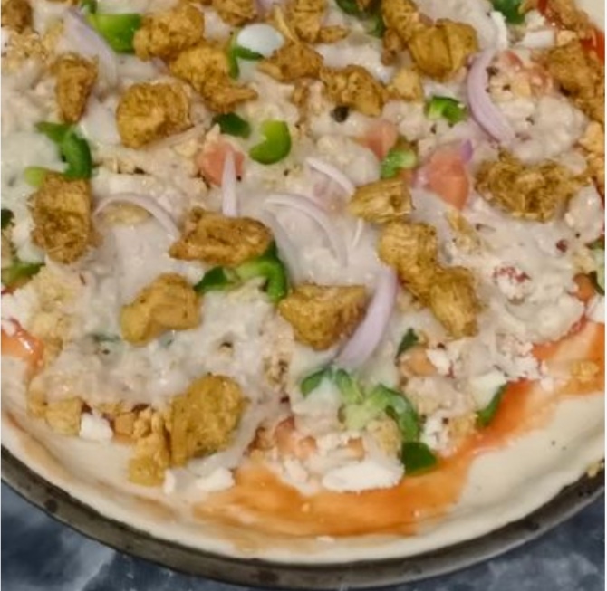 Loaded chicken pizza in a pan